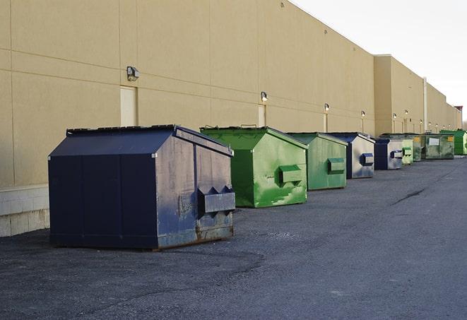 a collection of bright and vibrant dumpsters in a construction zone in Atkinson